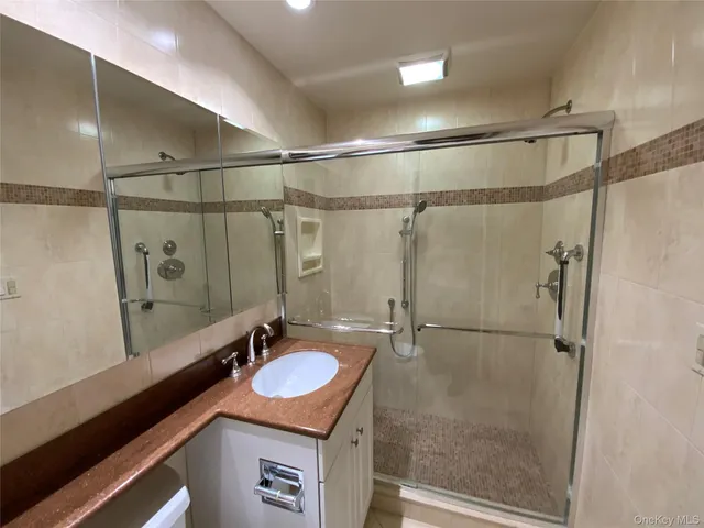 a bathroom with a sink mirror vanity and toilet