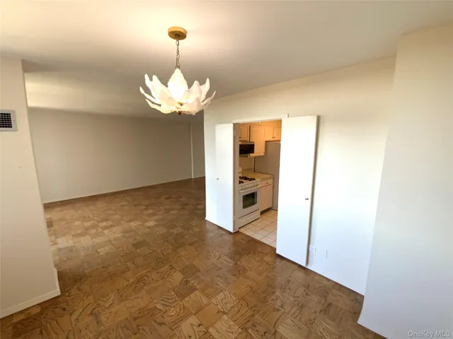 a view of an empty room with a cabinet