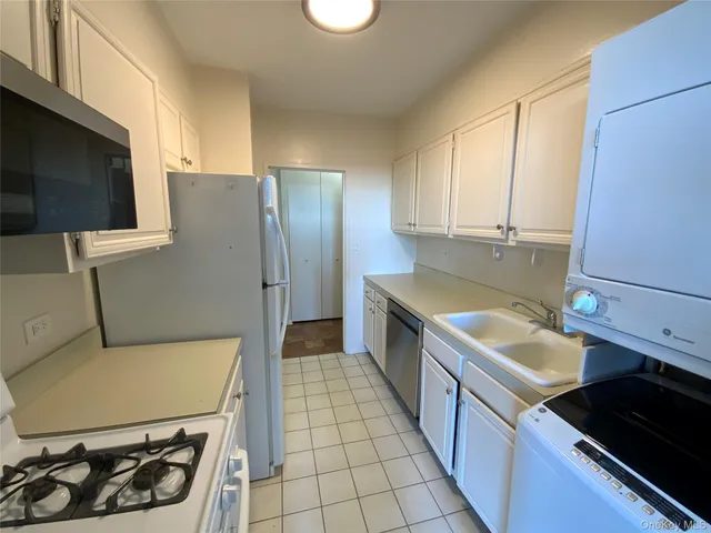 a kitchen with stainless steel appliances a stove a sink and a refrigerator