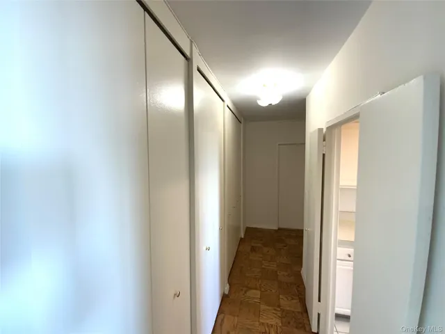 a view of a dining room with furniture a chandelier and window