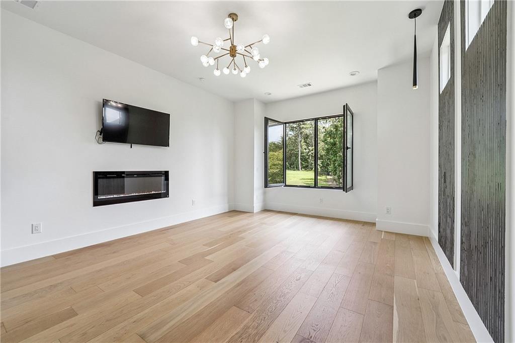 2551 Kilgore Road Buford, GA 30519 - Photo 14 of 45 a view of an empty room with a window and wooden floor