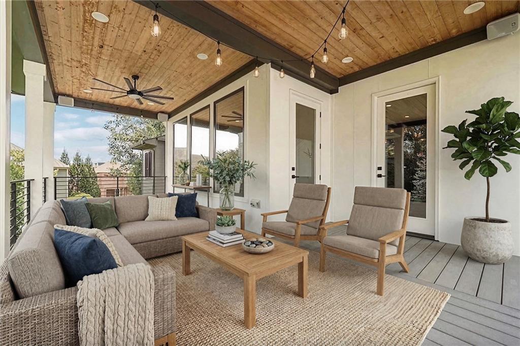 2551 Kilgore Road Buford, GA 30519 - Photo 21 of 45 a living room with furniture a chandelier and a dining table with wooden floor
