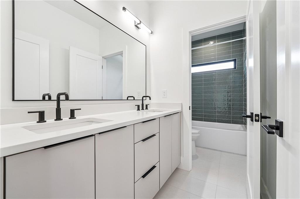 2551 Kilgore Road Buford, GA 30519 - Photo 25 of 45 a bathroom with a bathtub a sink a shower and a mirror