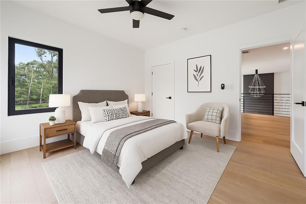 2551 Kilgore Road Buford, GA 30519 - Photo 35 of 45 a bedroom with a bed wooden floor and window