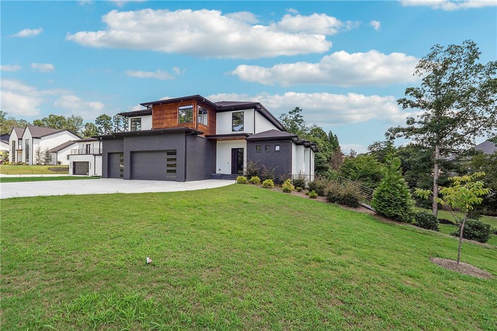 2551 Kilgore Road Buford, GA 30519 - Photo 39 of 45 a view of a big house with a big yard and large tree