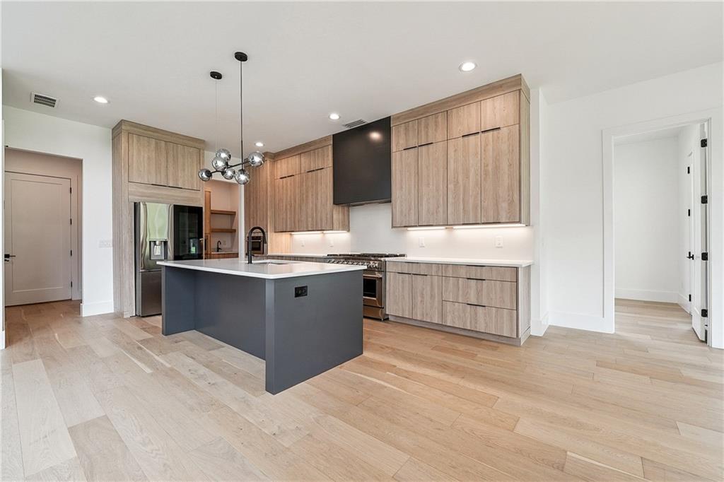 2551 Kilgore Road Buford, GA 30519 - Photo 7 of 45 a large kitchen with kitchen island a sink stainless steel appliances and cabinets