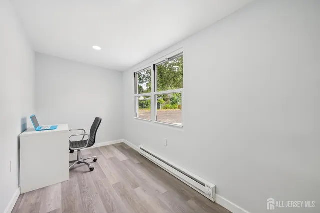 a view of a room with wooden floor and a window