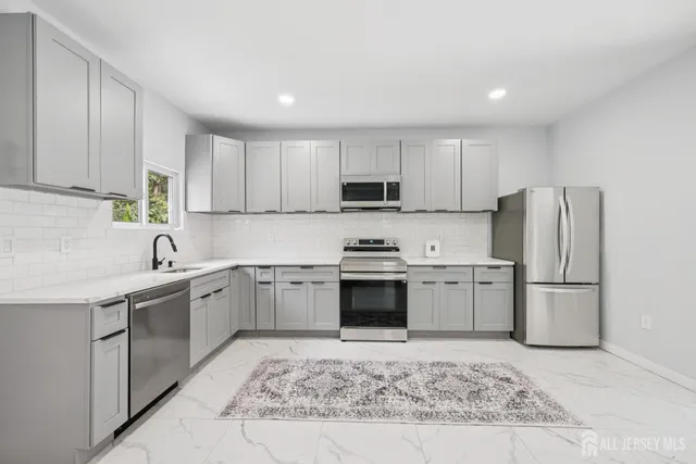 a kitchen with a sink stove and refrigerator