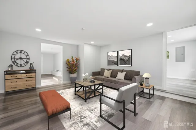 a living room with furniture and wooden floor