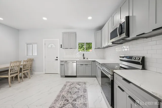 a kitchen with a sink stove and cabinets