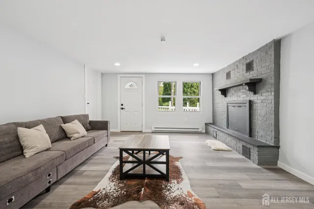 a bedroom with a large bed and wooden floor