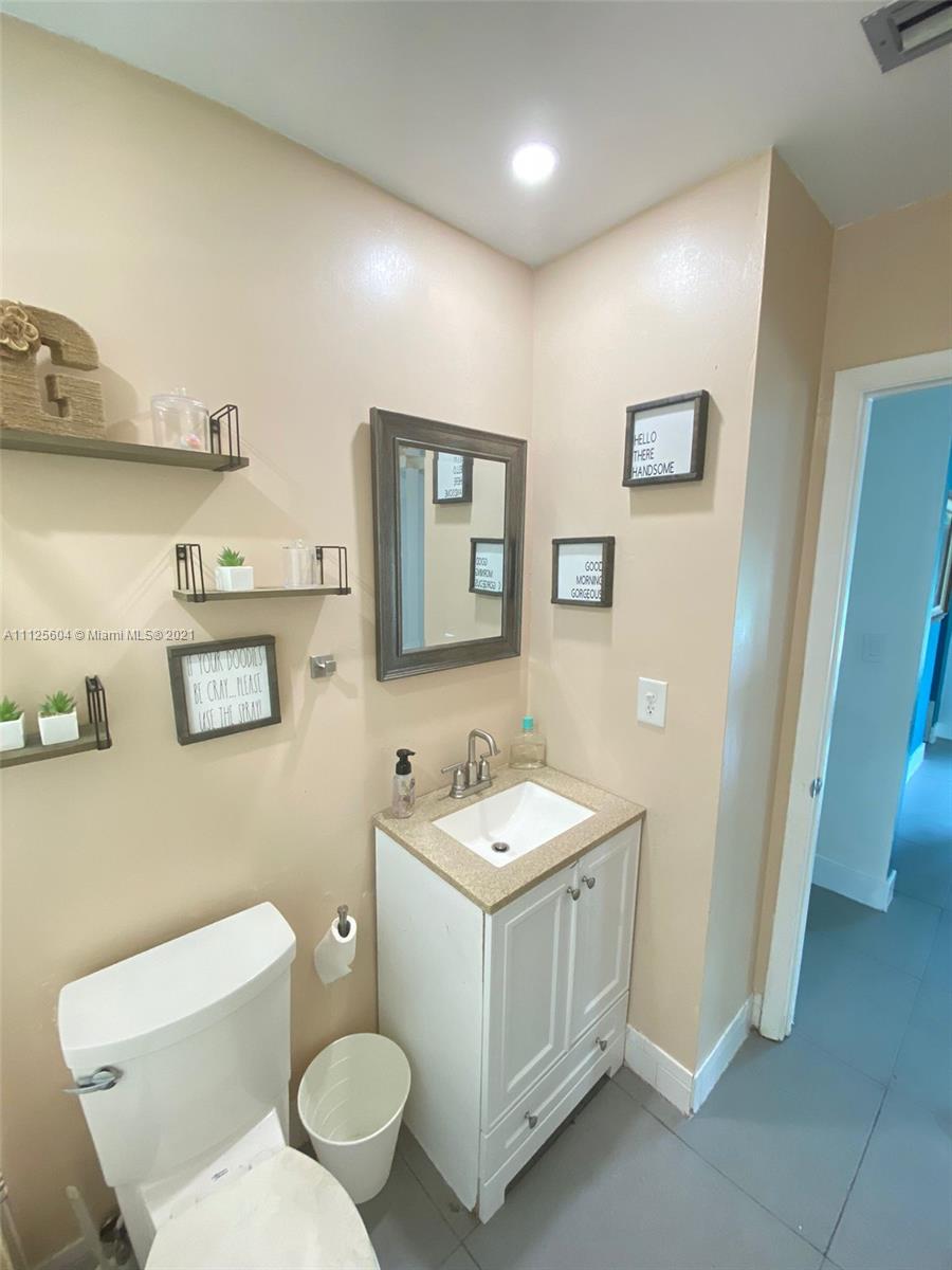Kendale Lakes Miami, FL 33183 - Photo 2 of 17 a bathroom with a toilet sink and mirror