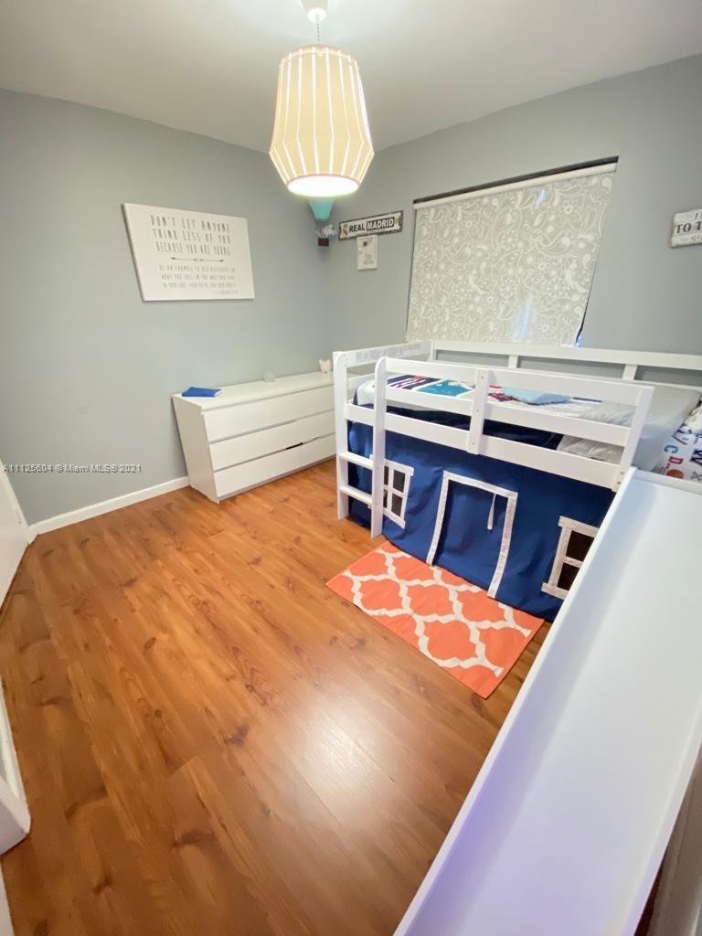 Kendale Lakes Miami, FL 33183 - Photo 13 of 17 a room with a bed and a chandelier