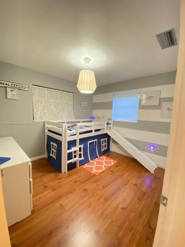 Kendale Lakes Miami, FL 33183 - Photo 14 of 17 a living room with a piano and a flat screen tv