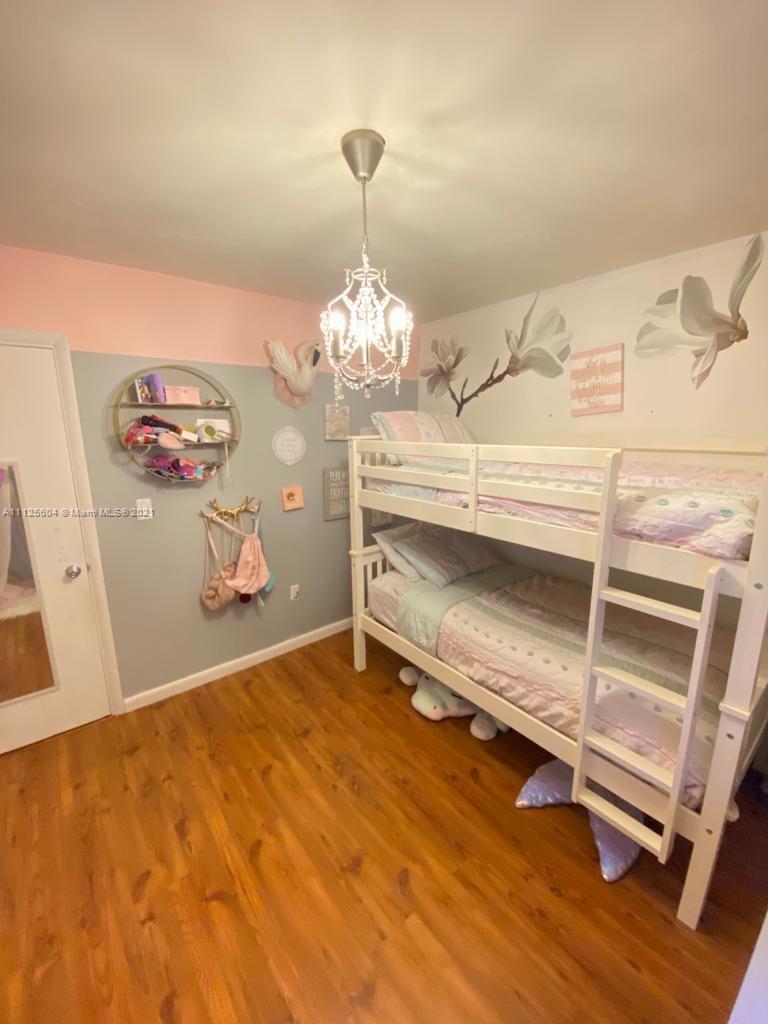 Kendale Lakes Miami, FL 33183 - Photo 10 of 17 a room with a mirror and a ceiling fan