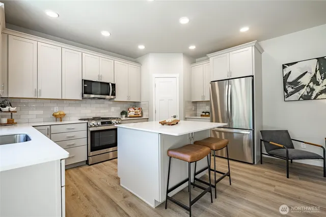 a dining room with furniture a rug and wooden floor