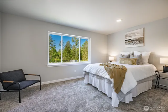 a bedroom with a bed and a painting on the wall