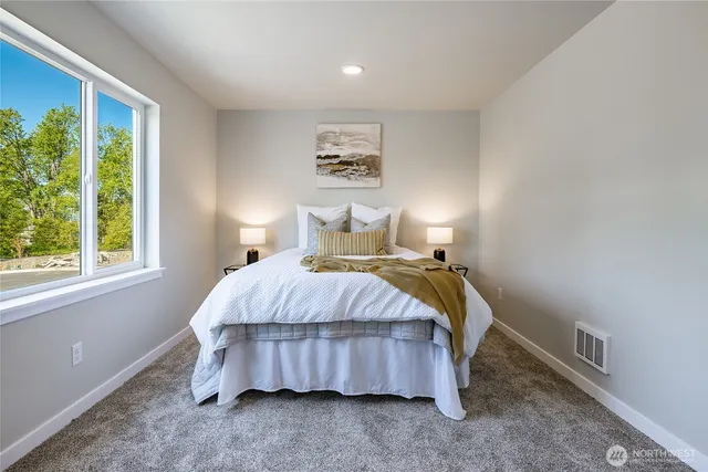 a bedroom with a bed and chair