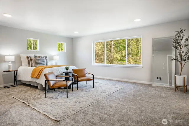 a bedroom with a bed and a couch