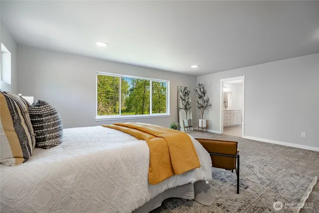 a bedroom with a bed a table and chair