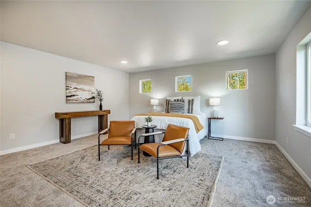 a spacious bedroom with a bed and a window