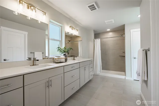 a bathroom with a shower and a glass door