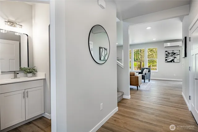 a view of a workspace with furniture and wooden floor