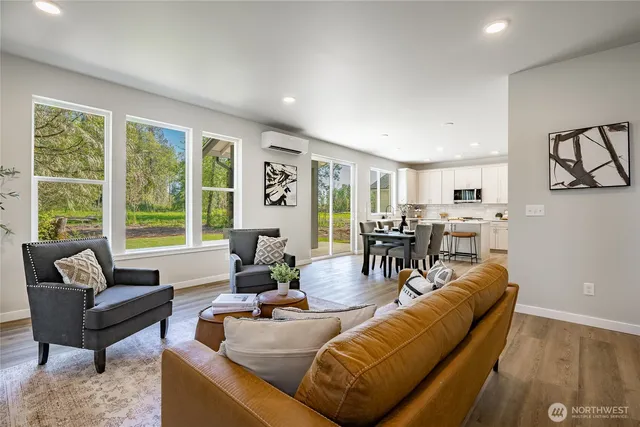 a living room with furniture and kitchen view
