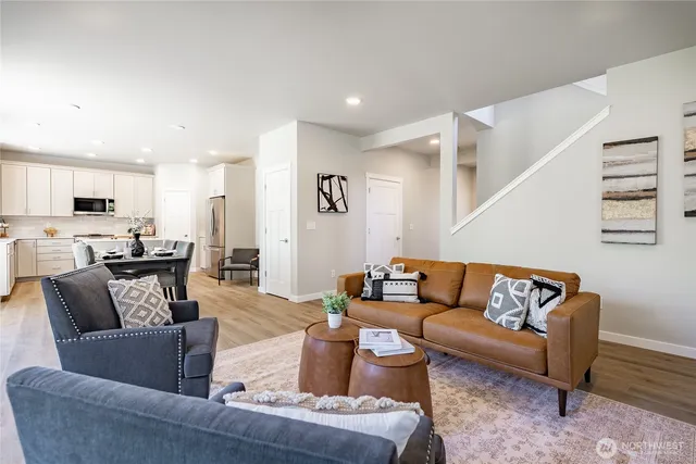 a kitchen with a dining table chairs and refrigerator