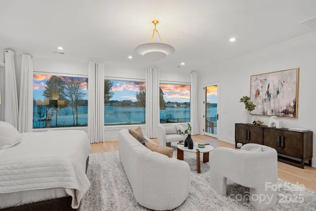 a view of a room with furniture and floor to ceiling window