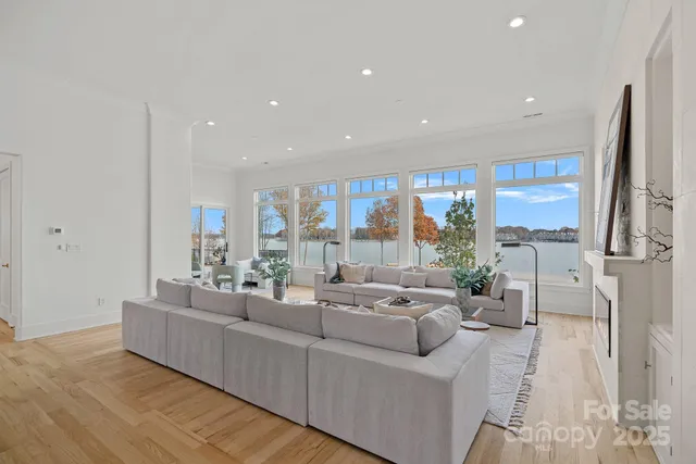 a living room with patio furniture and a floor to ceiling window