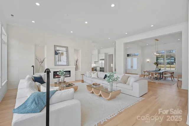 a living room with fireplace furniture and a large window