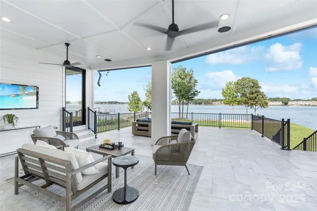 a view of a hallway with wooden floor and windows