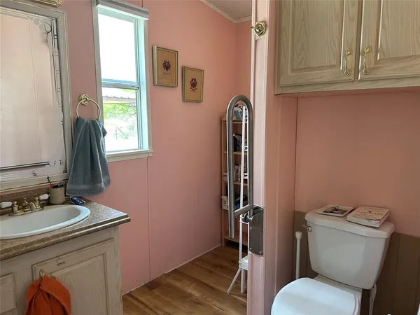 a utility room with stainless steel appliances granite countertop a sink a stove a refrigerator and cabinets