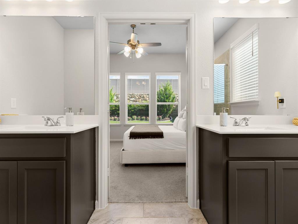 166 Palo Duro Bend Rhome, TX 76078 - Photo 22 of 40 Primary bathroom featuring dual vanities, walk-in shower, and ample storage.