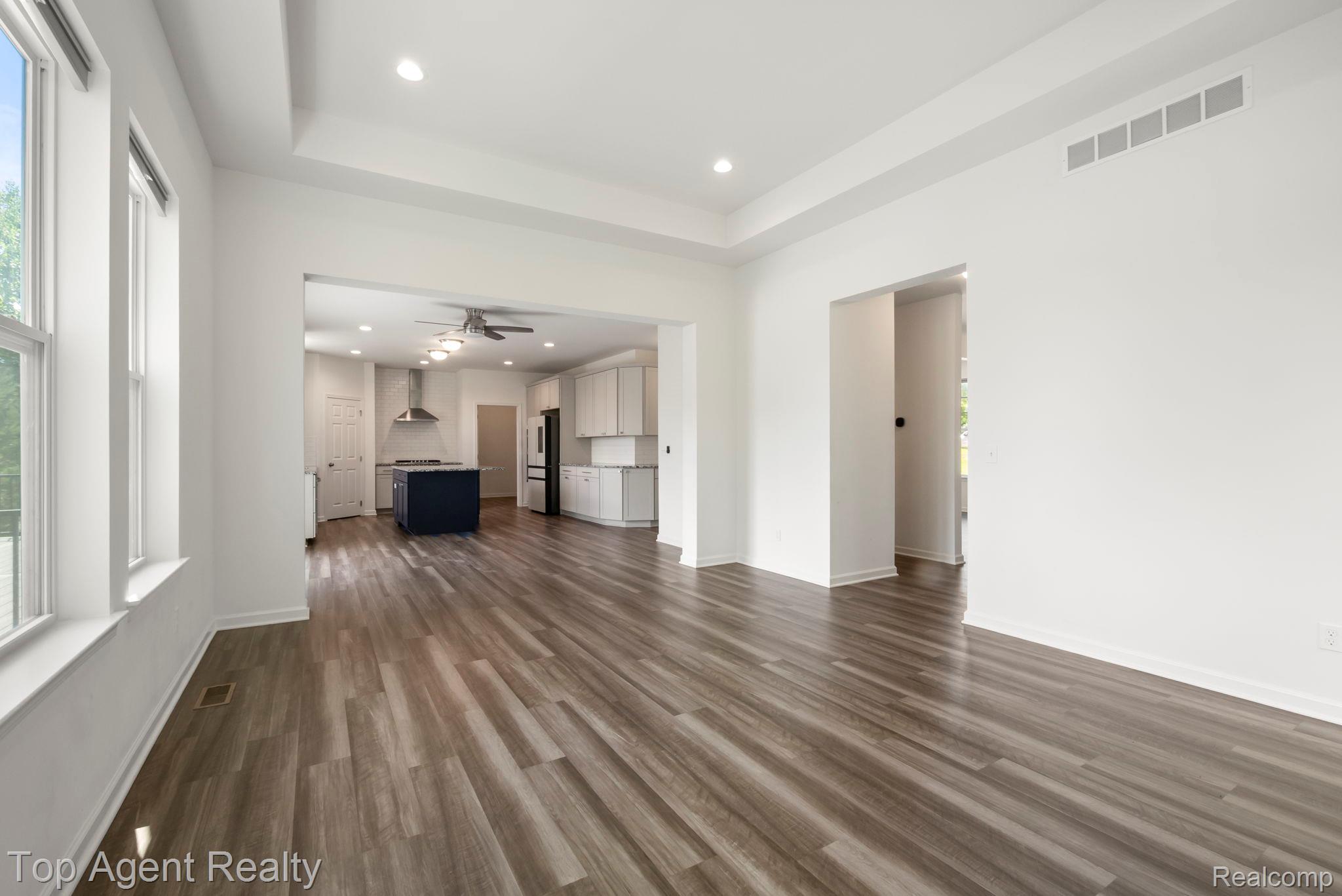 63770 Dequindre Road Washington, MI 48095 - Photo 10 of 61 Spacious interior featuring wood-finish flooring, recessed lighting, and a tray ceiling