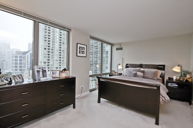2 East Erie Street, Unit 1611 Chicago, IL 60611 - Photo 7 of 12 a bed room with a bed and a window