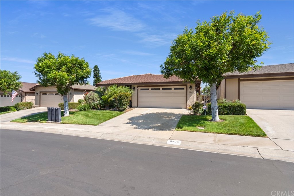 a front view of a house with a yard and a garage