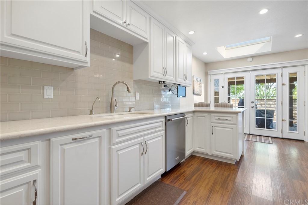 5965 Maybrook Circle Riverside, CA 92506 - Photo 16 of 34 a kitchen with granite countertop a sink stainless steel appliances and cabinets