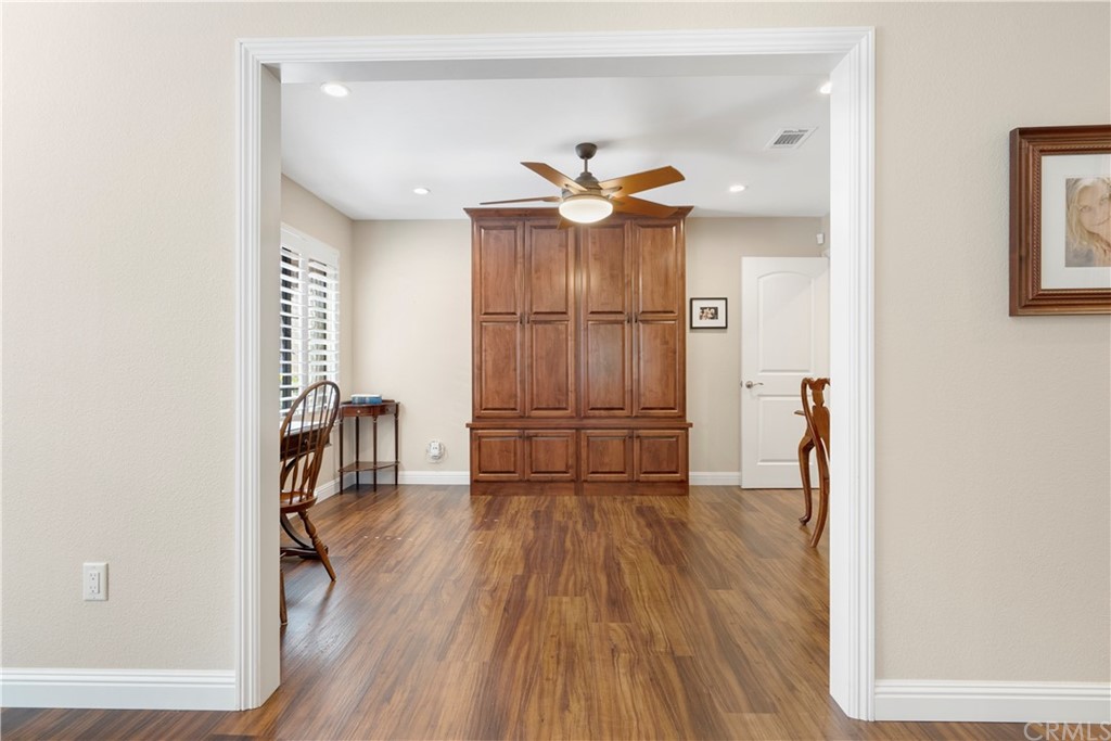 5965 Maybrook Circle Riverside, CA 92506 - Photo 19 of 34 a view of a hallway with wooden floor and a bathroom