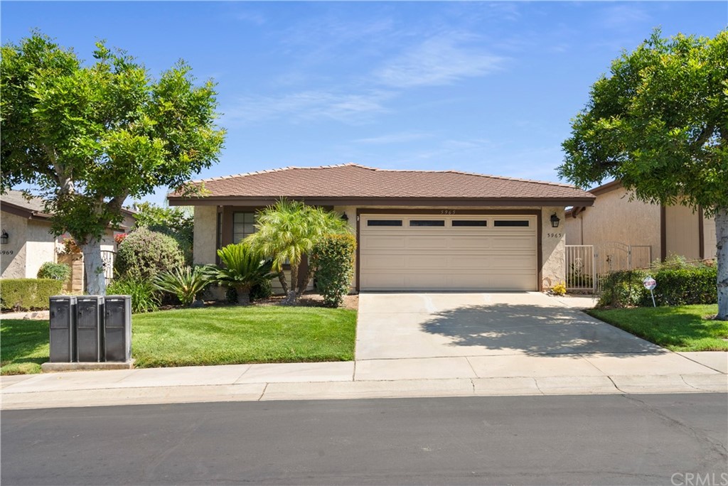 5965 Maybrook Circle Riverside, CA 92506 - Photo 2 of 34 a front view of a house with a garden and trees