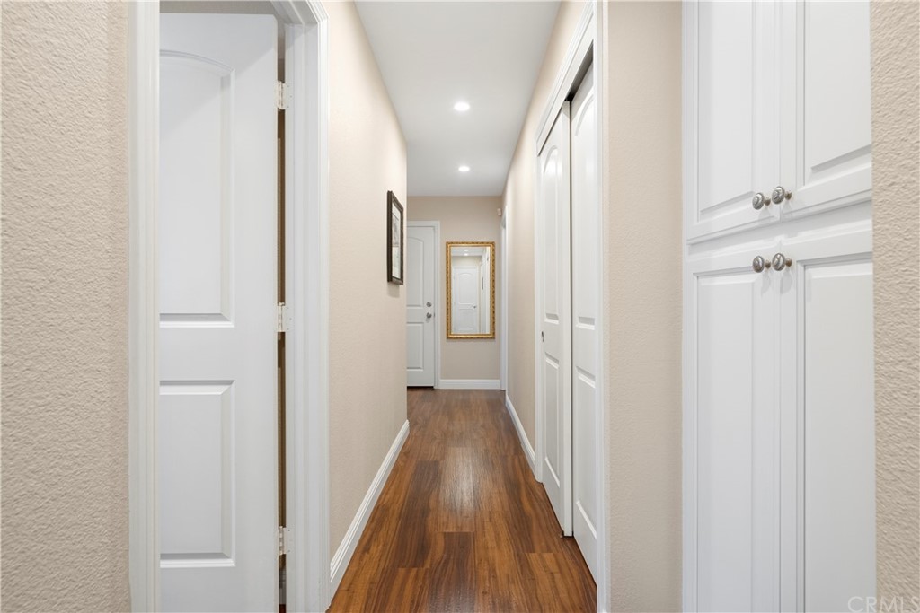 5965 Maybrook Circle Riverside, CA 92506 - Photo 22 of 34 a view of a hallway with wooden floor