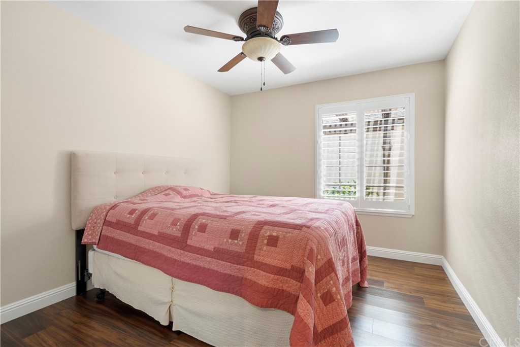 5965 Maybrook Circle Riverside, CA 92506 - Photo 23 of 34 a bedroom with a bed and a chandelier