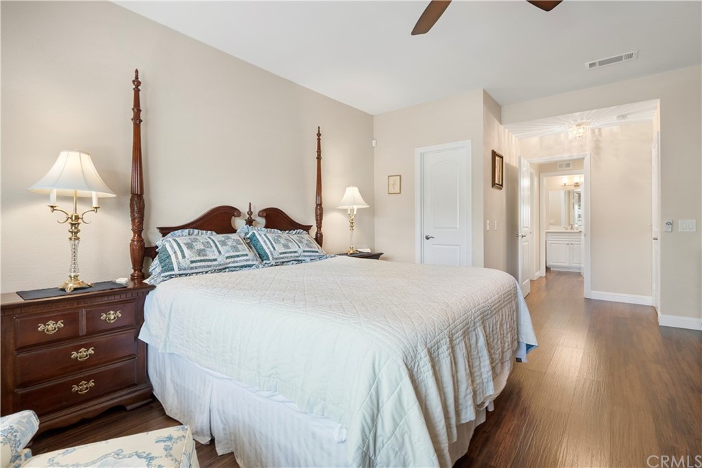 5965 Maybrook Circle Riverside, CA 92506 - Photo 26 of 34 a bedroom with a bed and wooden floor