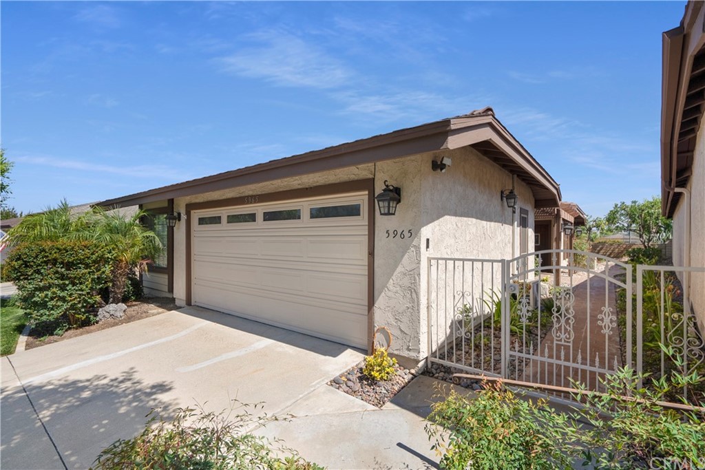 5965 Maybrook Circle Riverside, CA 92506 - Photo 4 of 34 a front view of a house with garage