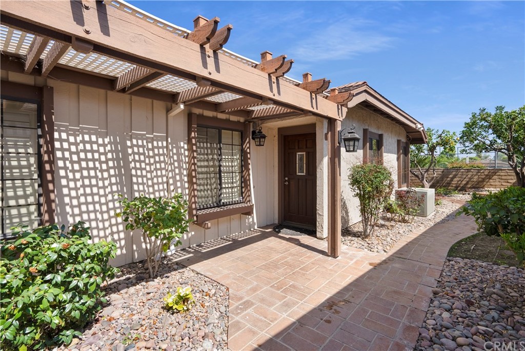 5965 Maybrook Circle Riverside, CA 92506 - Photo 6 of 34 a view of a house with a small yard and plants