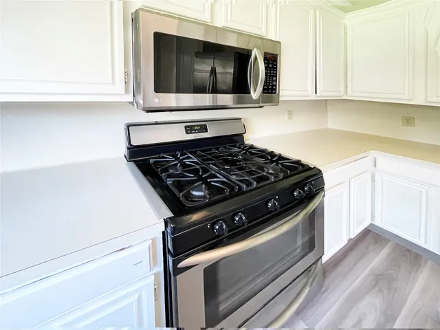 a stove top oven sitting inside of a kitchen