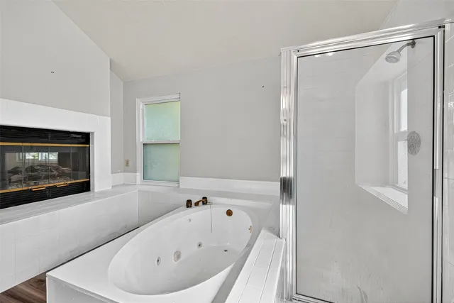 a bathroom with a bathtub and a window