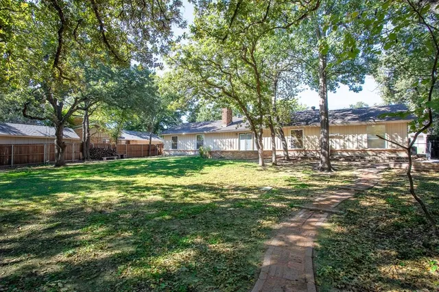 a swimming pool with outdoor seating and yard