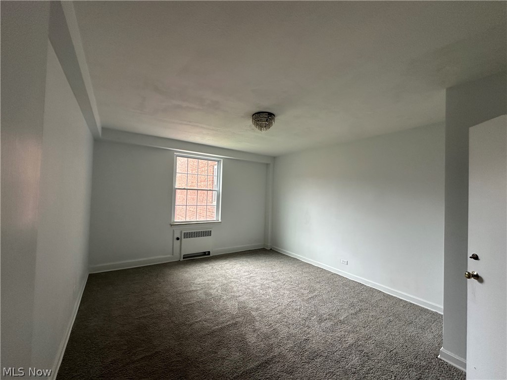 13800 Fairhill Road, Unit 416 Shaker Heights, OH 44120 - Photo 7 of 13 Spacious room featuring neutral carpeting and white walls